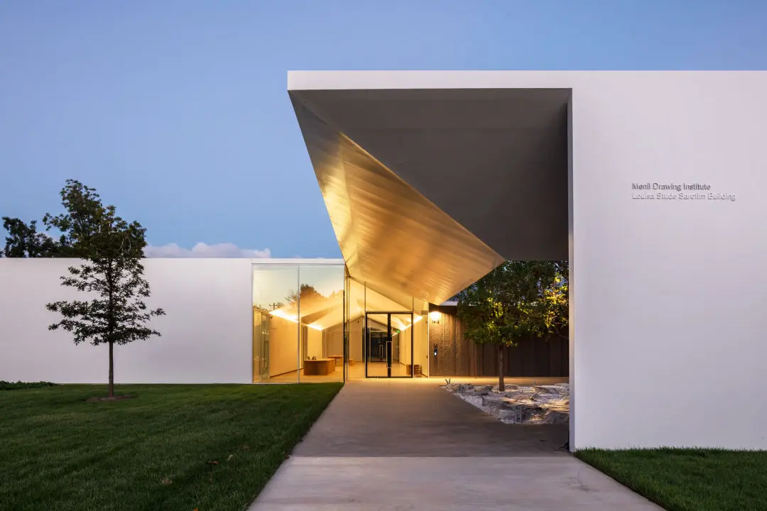 A modern white building at twilight.