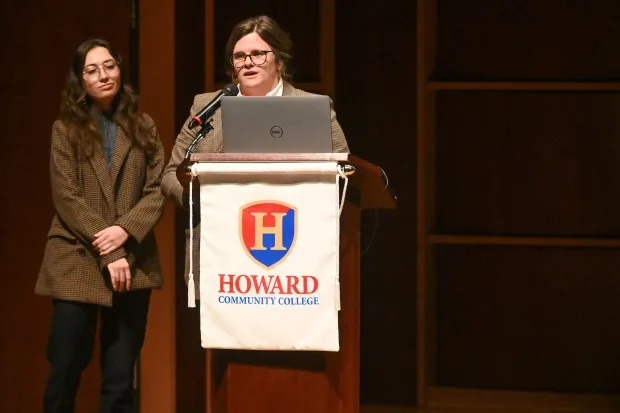 Amanda Golden, co-founder of Designing Local, speaks at the podium while joined by Jasmine Metcalf, left, an urban planner with the company, during the announcement of the Howard County Arts and Culture Plan, held at Howard Community College's Horowitz Center on Thursday. (Brian Krista/Staff)