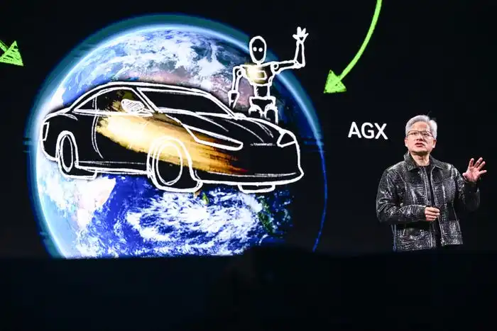 Jensen Huang on a stage in front of an image featuring a car, a robot, and the Earth.