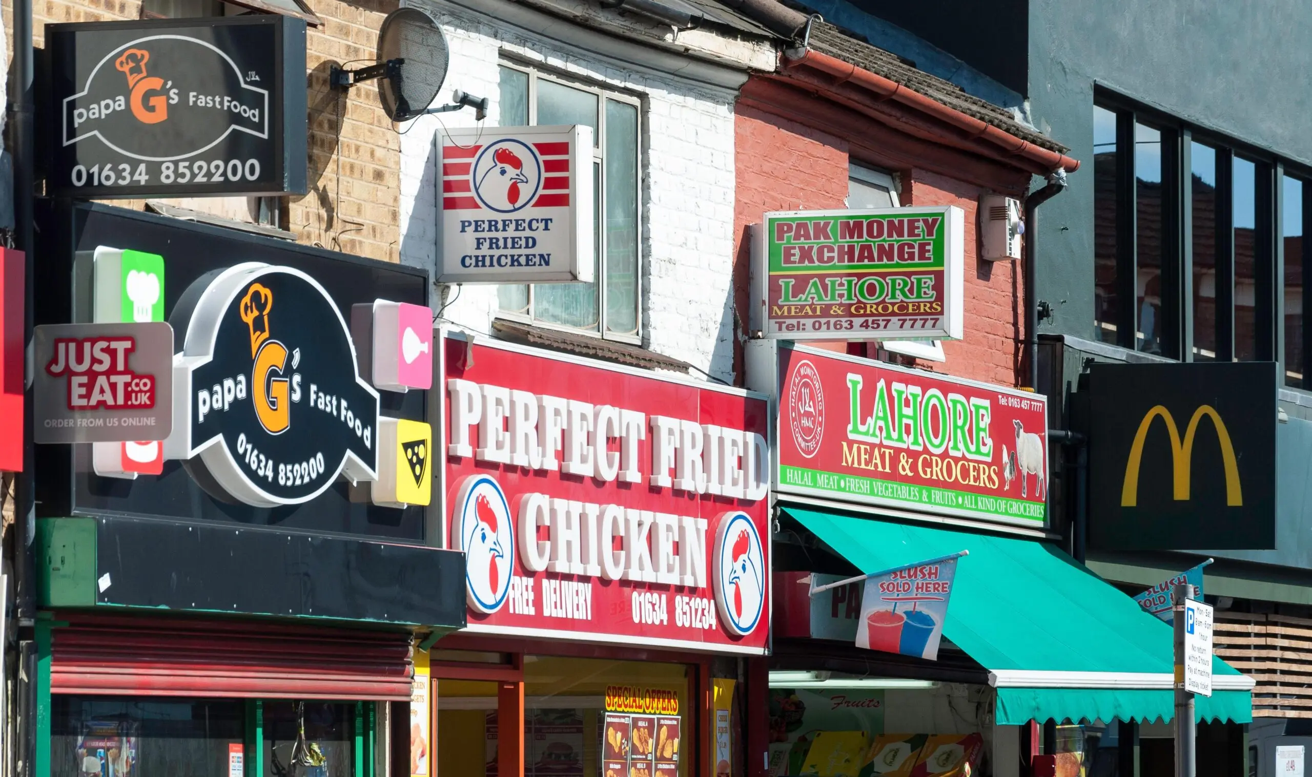 Fast food restaurant signs on a street.