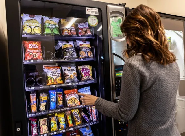 Ireland Army Health Clinic Dietician Laura Bottoms chooses a FitPick vending machine option at Fort Knox, Kentucky, Jan. 28, 2025. These new items were put in as part of a Fort Knox nutrition environment working group initiative to improve the...