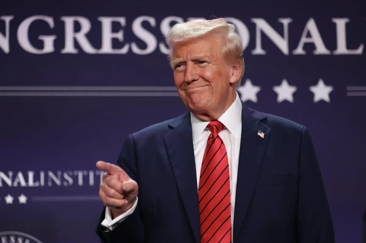 Donald Trump gestures to crowd at conference