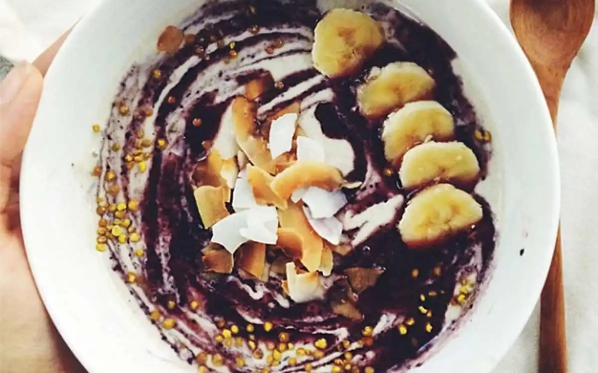 vegan raw activated buckwheat and coconut porridge with blueberry sauce