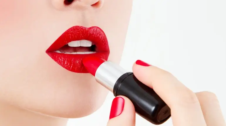 Red lipstick is timeless, but 2025 brings unique undertones like brick, neon, and metallic reds. Pair bold red lips with glowing skin for a powerful statement (Image: Canva)