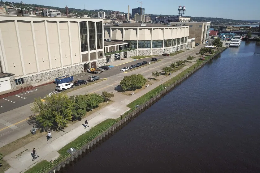 People along the seawall behind the DECC.