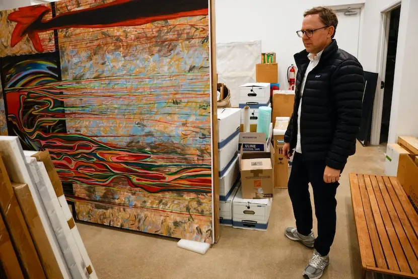 James Cope, art gallery owner, looks at boxed paintings in the storage room of the James...