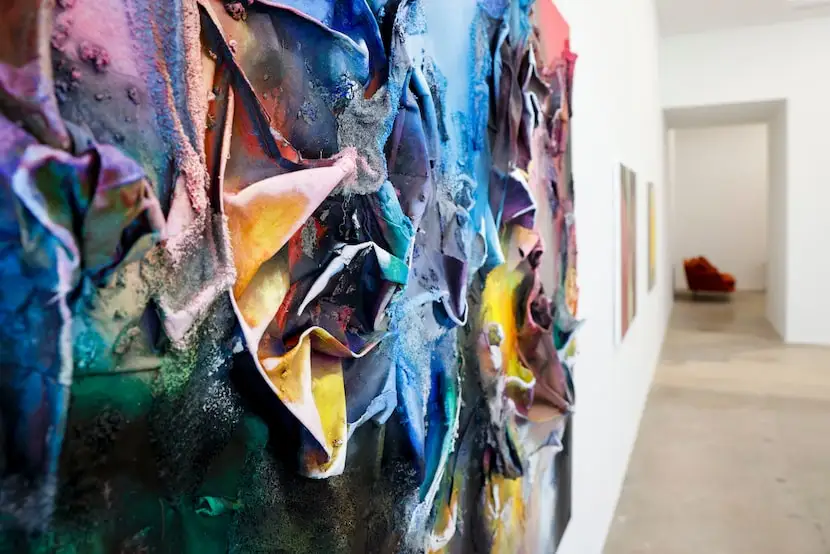 A painting by Leslie Martinez hangs in the front of the James Cope Gallery in Dallas, on...