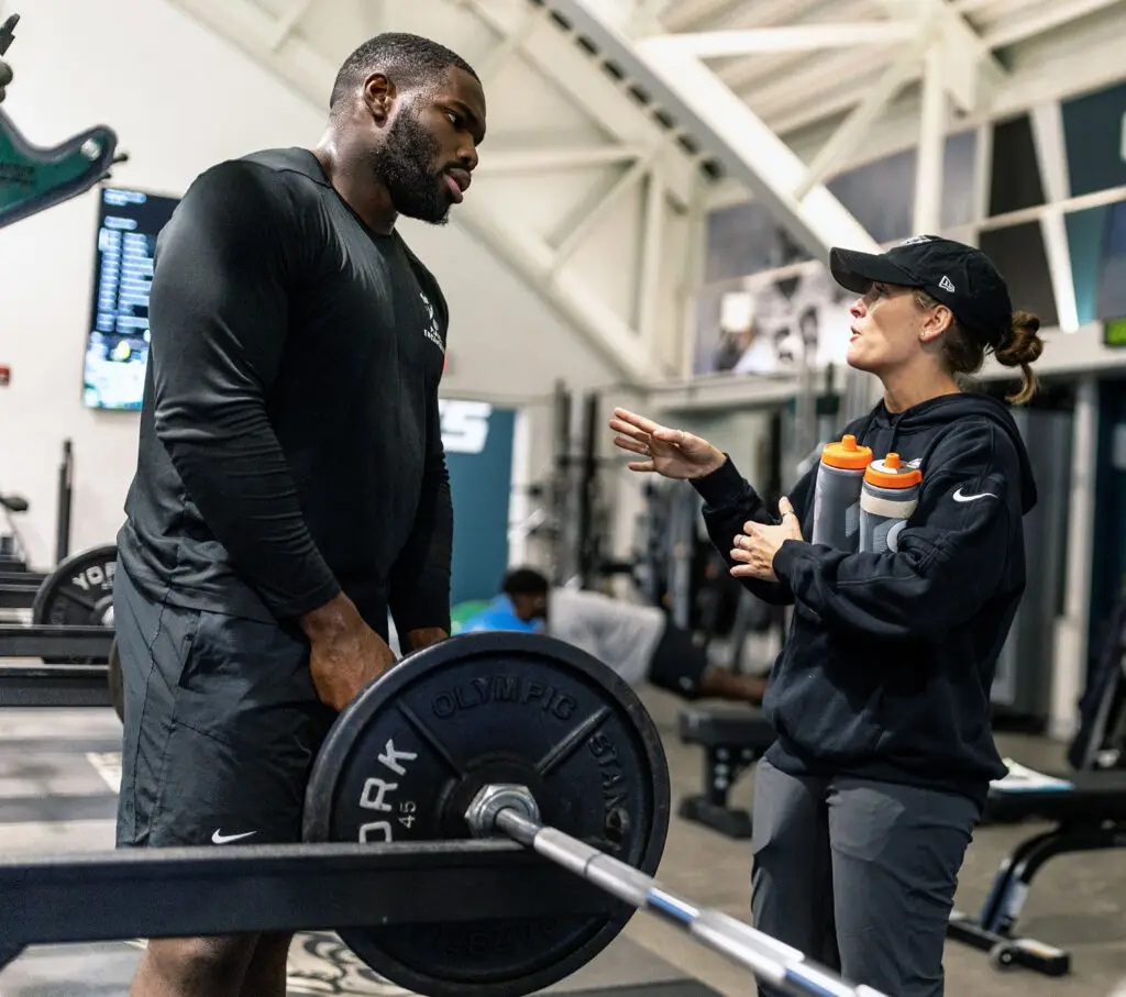 Nutritionist talking with player in Eagles weight room