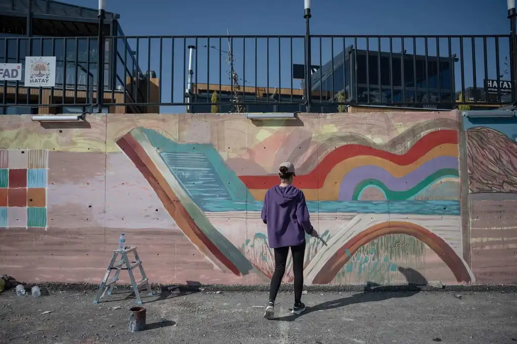 A painter paints graffiti on a wall at the Antakya Art and Culture Market in Antakya, Turkey. Photo: AFP