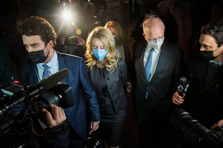 Elizabeth Holmes is seen leaving court followed by members of the media