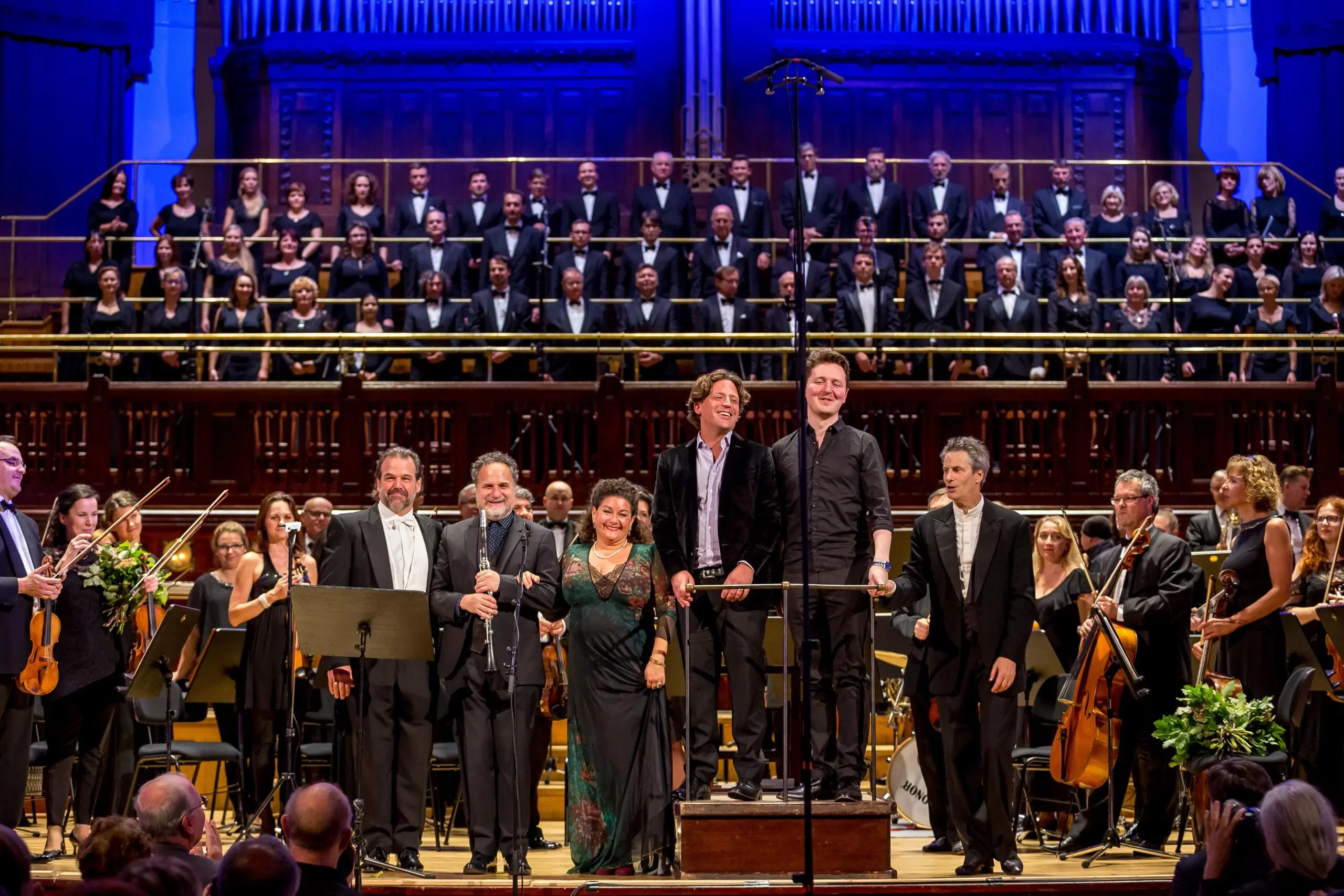 Tenor soloist Richard Troxell, clarinet soloist David Krakauer, soprano soloist Sharon Azrieli CQ, 2016 AMP Laureates Brian Current and Wlad Marhulets, and conductor Steven Mercurio with the Czech National Symphony Orchestra and Choir give the European premiere of the 2016 AMP prize-winning works at Smetana Hall in Prague, Czechia (2016). Photo: Courtesy of AMP