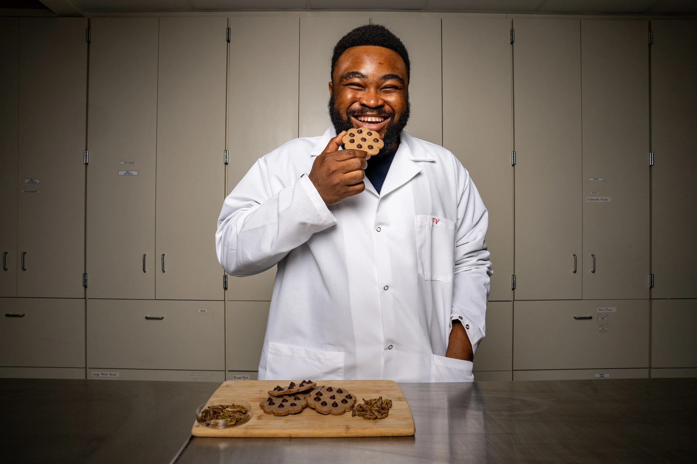 Graduate student Ikenna Okehie holds a fermented/bioprocessed insect cookie