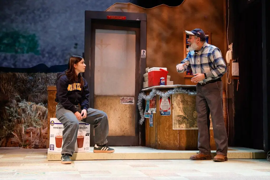 On stage, Mayelah Barrera and Bobby Plasencia portray Mia and Moises, seated together on a bench in "In Her Bones."