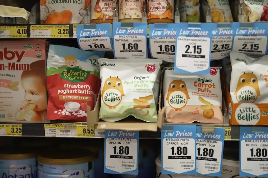 Toddler food products on a supermarket shelf with price tags. 