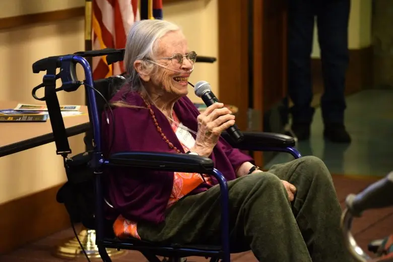 a woman speaks into a microphone