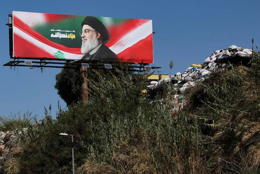 a billboard of a man with a busy beard above a road