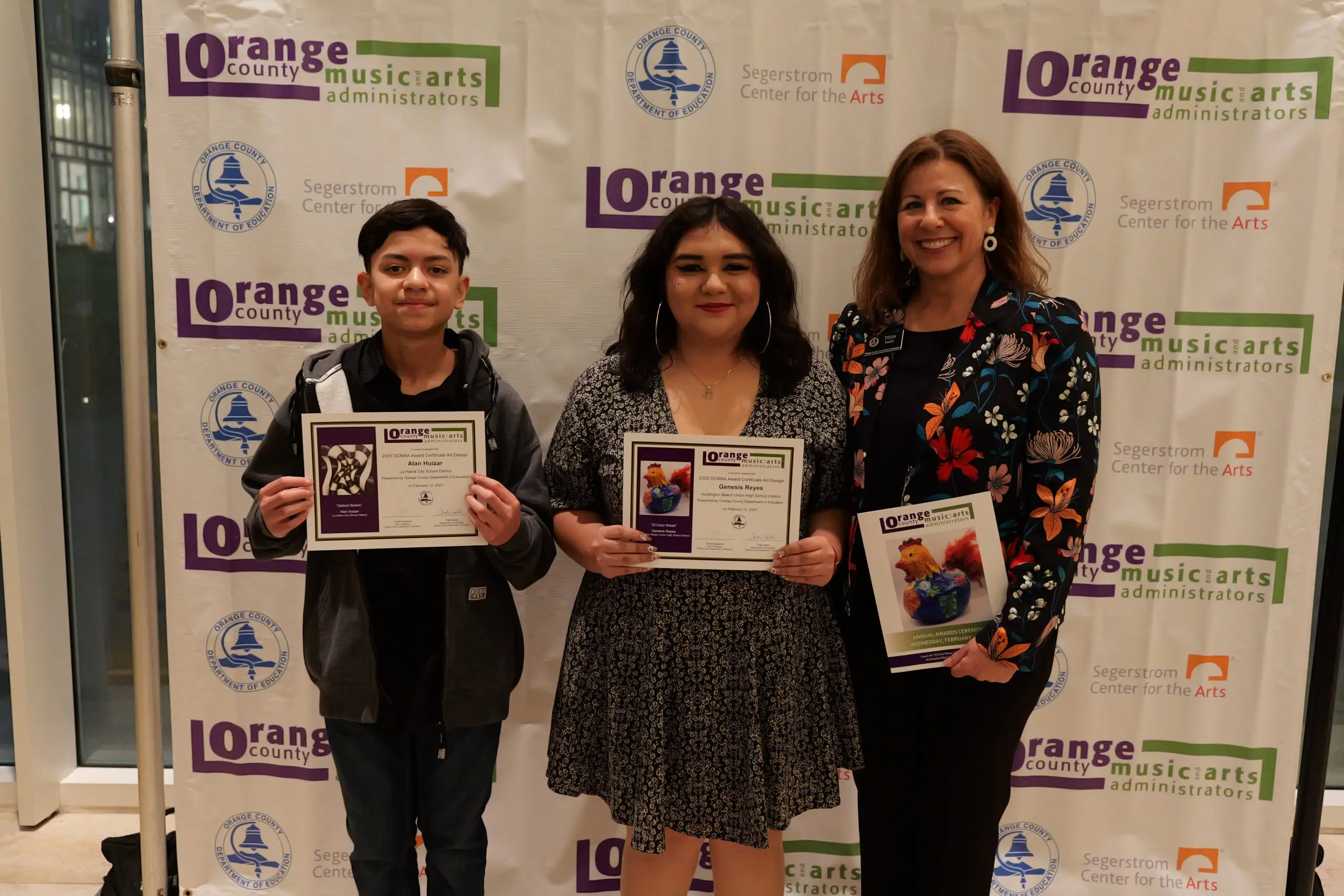 Alan Huizar of the La Habra City School District and Genesis Reyes of the Huntington Beach Union High School District stand with Trish Walsh, OCDE’s administrator of humanities. Both students were recognized for their artwork, which was featured on the event program and recipient certificates.