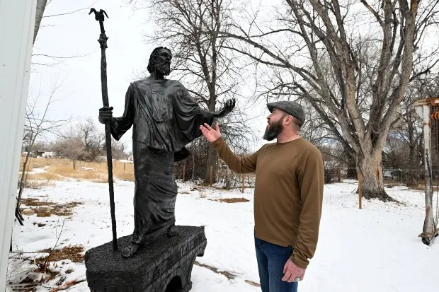 Elijah Nugent shows the sculpture of St. Patrick Friday, Feb. 21, 2025, he created with long-time Loveland sculptir Jack Kreutzer at his studio in Loveland. The piece will be placed at Benson Sculpture Park.     (Jenny Sparks/Loveland Reporter-Herald)