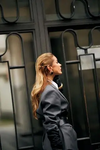 woman in a gray jacket with long blonde hair