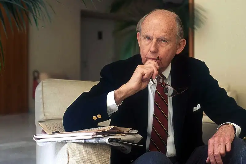 Samuel Huntington holds his hand to his chin while sitting in an office.