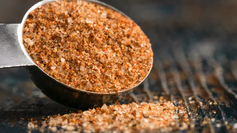 Close up of Cajun seasoning spilling out of measuring spoon