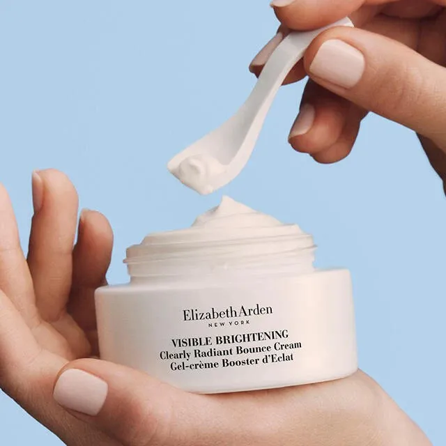 Elizabeth Arden Visible Brightening Clearly Radiant Bounce Cream being scooped from jar.