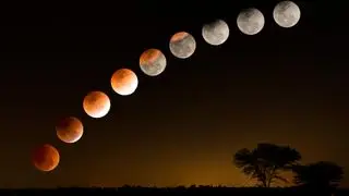 phases of a total lunar eclipse above the countryside