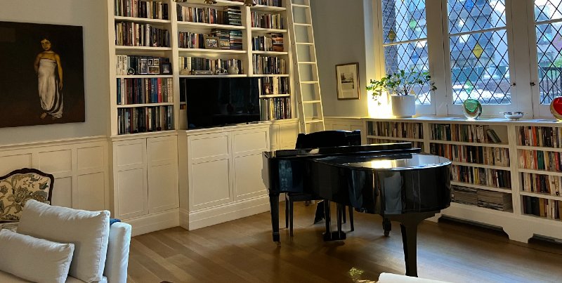 Historic 1900s NYC Apartment Hides a Television in its Bookshelf Cabinetry