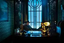 Christopher Brown, who plays the Manager, poses for a photo at his desk at the John Wick Experi ...