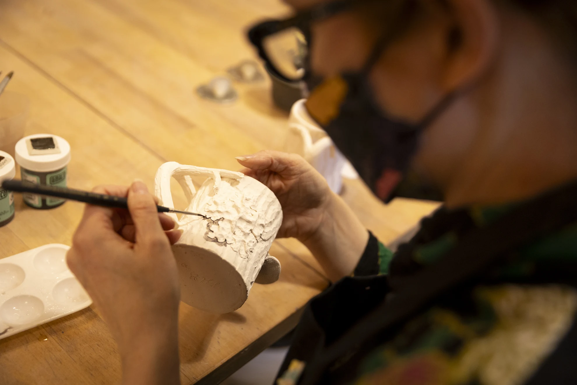 Fionnuala Gerrity, Conservation Technician at Harvard Library Preservation Services and ceramicist, working on a piece of ceramics at Indigo Fire Pottery Studio in Belmont, MA.