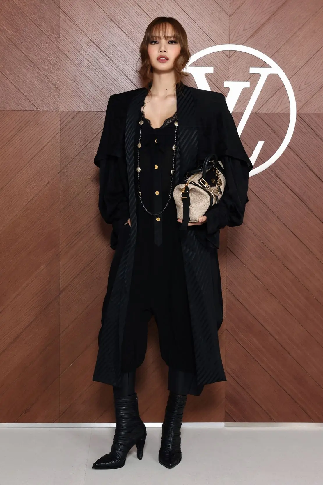 Fresh off the release of her new album, Blackpink’s Lisa layered a black camisole over trousers tucked into heeled boots.