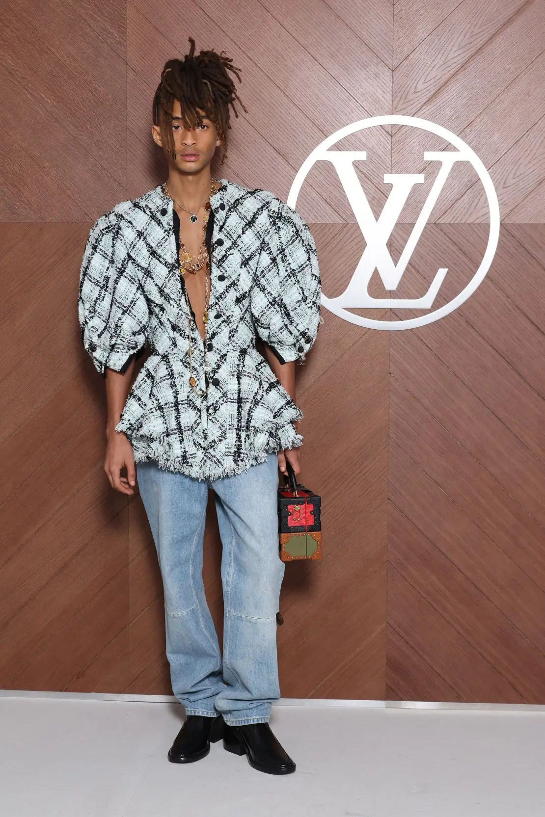 Jaden Smith, son of Jada Pinkett-Smith and Will Smith, styled a Louis Vuitton peplum jacket with blue jeans and low-heeled shoes.