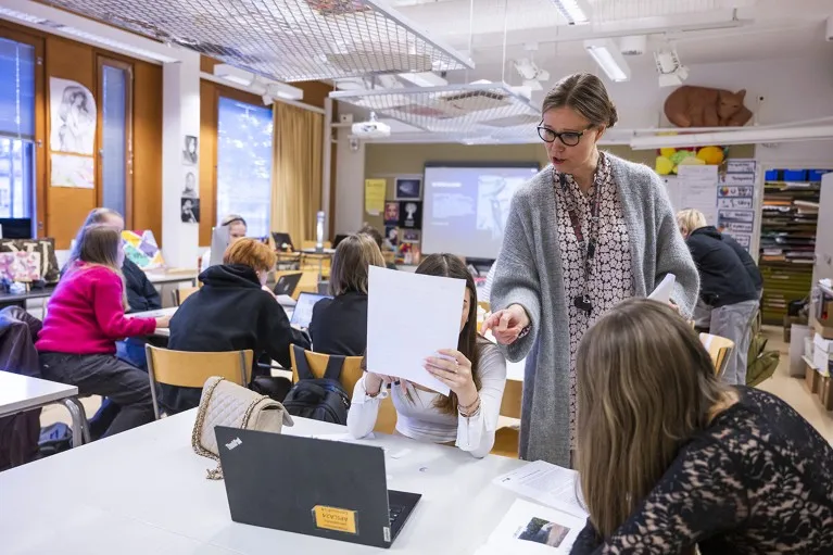 Students attend a class with a teacher guiding them at a school n Helsinki, Finland.