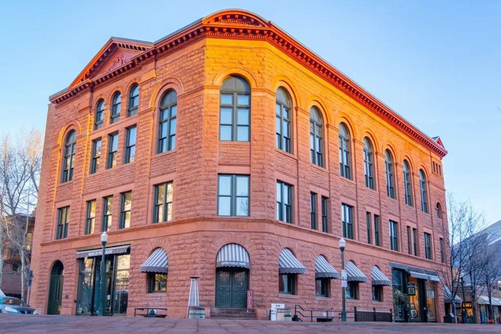 The three-story red brick Wheeler Opera House with green and white striped awnings.