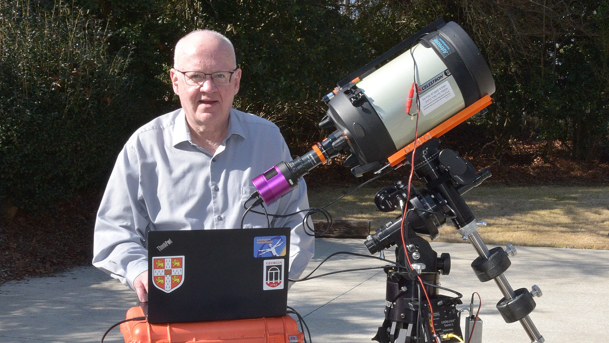 The author sitting by a telescope connected to the Altair Hypercam 26C APS-C Colour TEC, also connected to a laptop.
