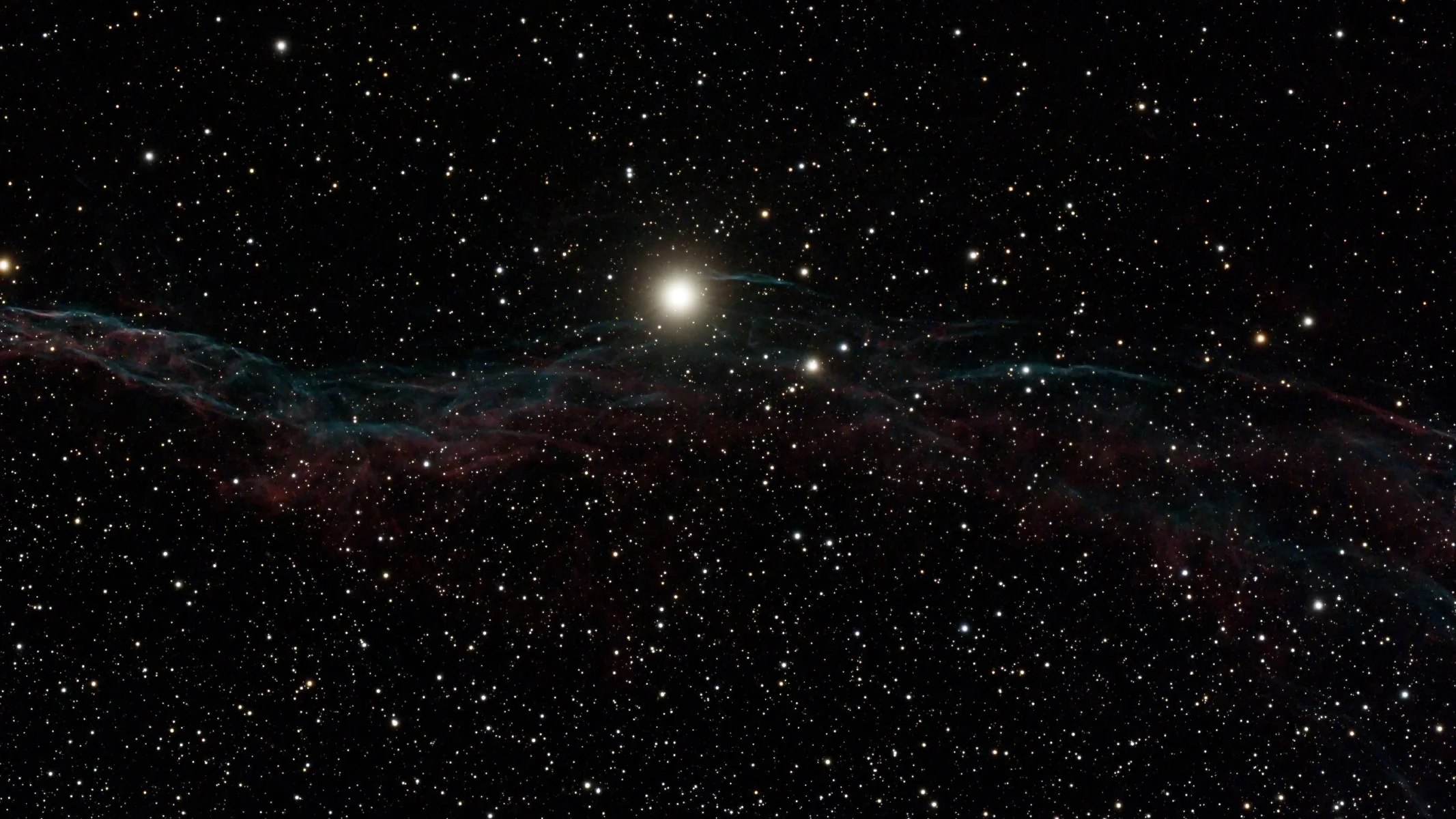 A deep space nebula, with an especially bright star in the middle.