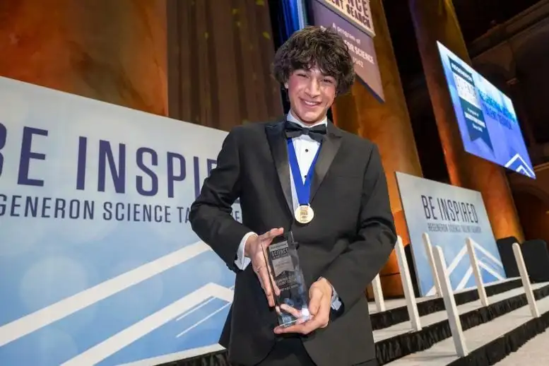 2025 Regeneron Science Talent Search Winner Matteo Paz Holds His Trophy