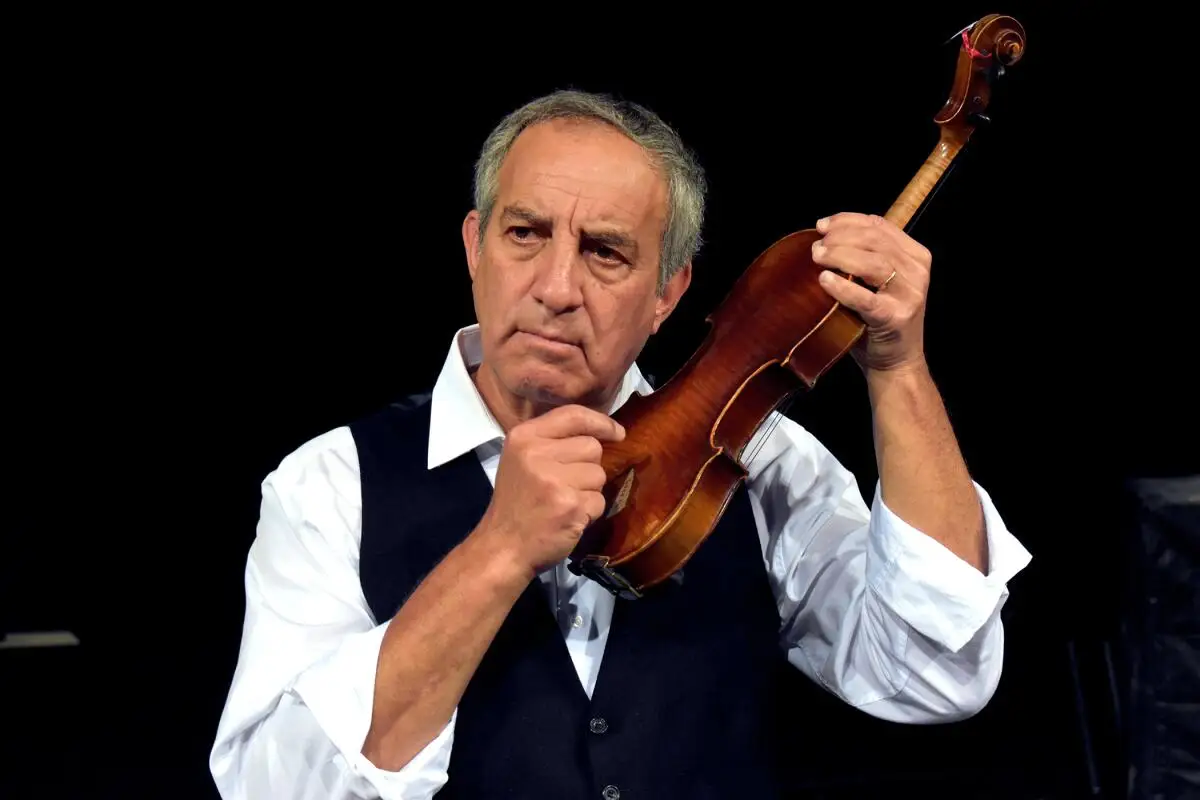 A man holding a violin.