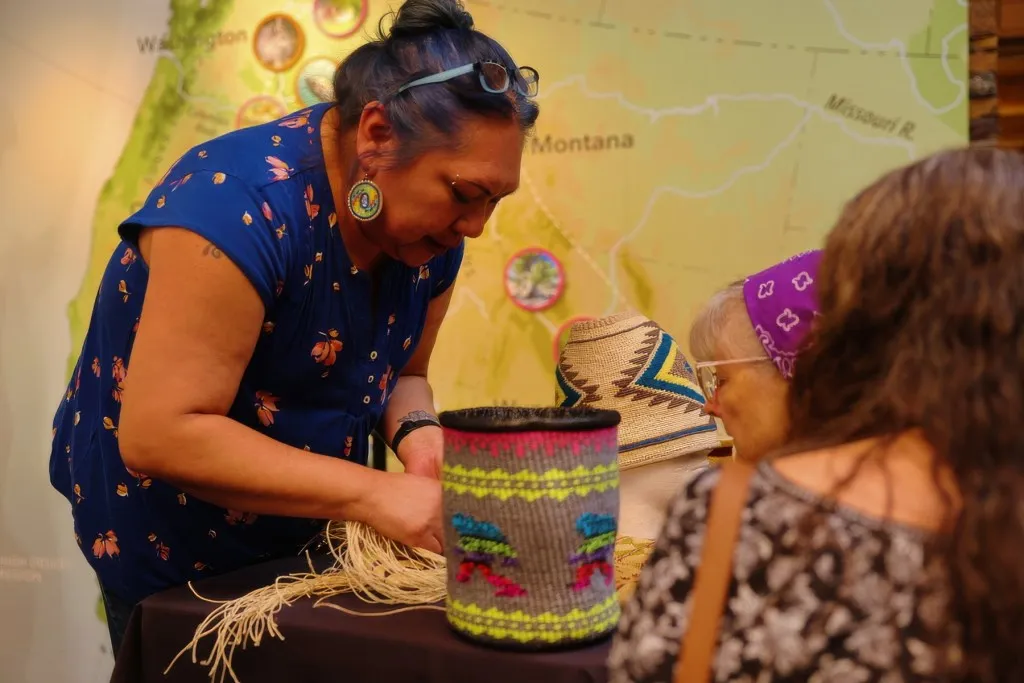 Kelli D. Palmer of Warm Springs shows the details in a cornhusk basket she made during a presentation at the High Desert Museum in Bend. Both the High Desert Museum and the Museum at Warm Springs have received large grants from the Oregon Community Foundation. Photo: Robert Davis, courtesy High Desert Museum.