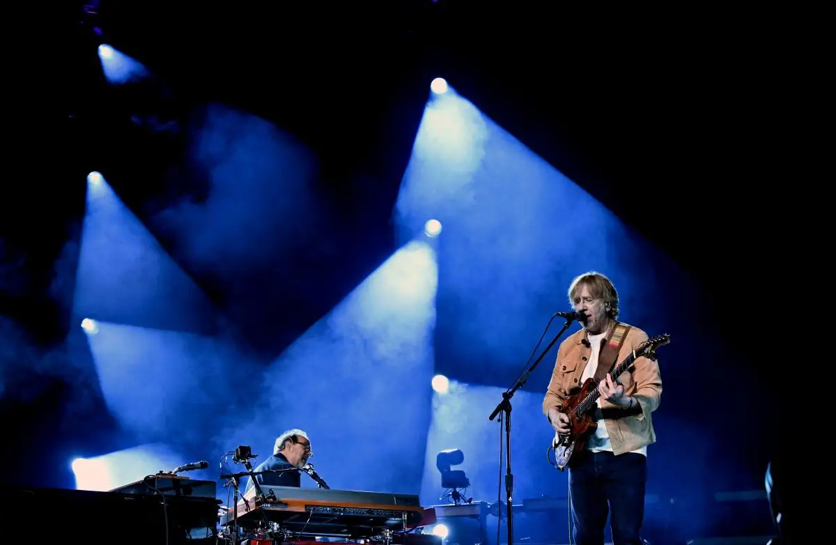 Keyboardist Page McConnell and guitarist-singer Trey Anastasio of the band Phish perform onstage.