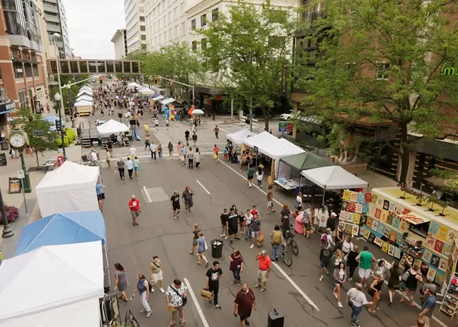 People fill the downtown Spokane streets as they browse booths at Terrain's Bazaar summer art market.