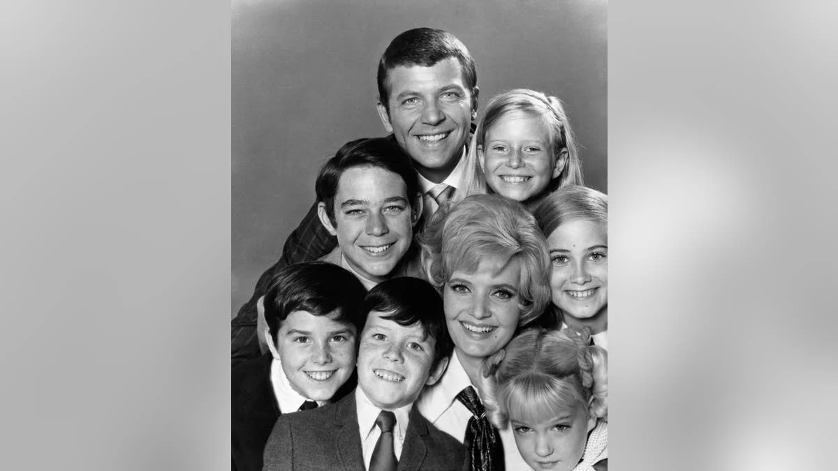 The Brady Bunch smiling in a photo