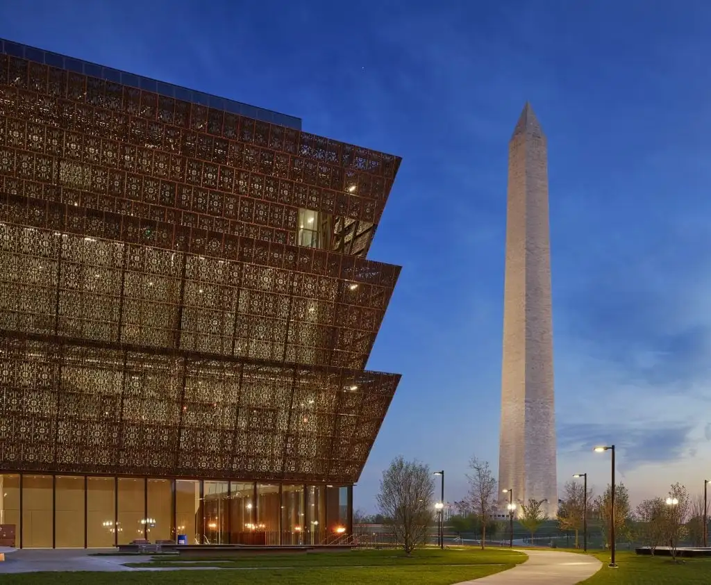 In the foreground, the National Museum of African American History and Culture. The Washington stands in the background.