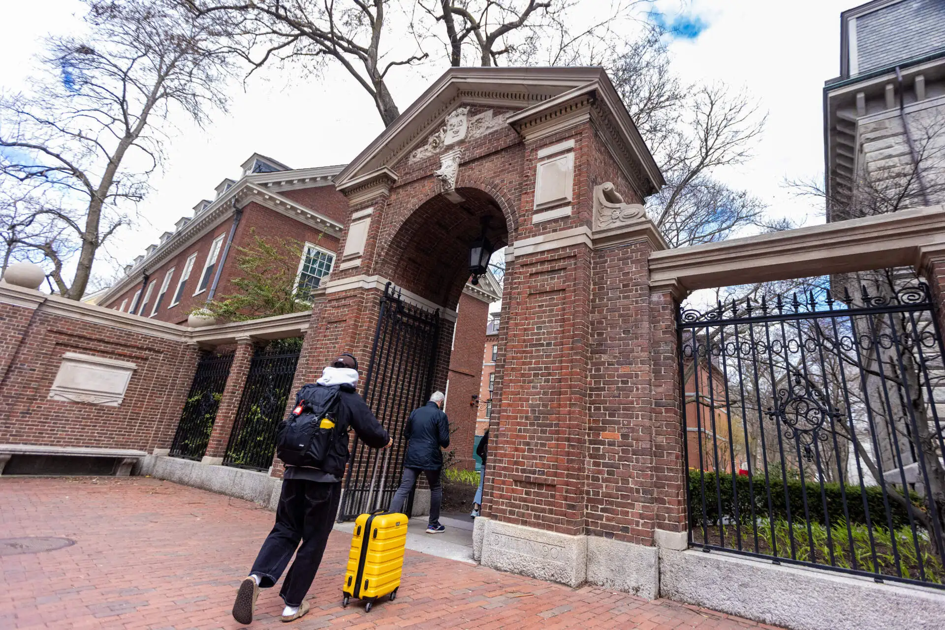 A student walks into Harvard Yard from Harvard Square. (Jesse Costa/WBUR)