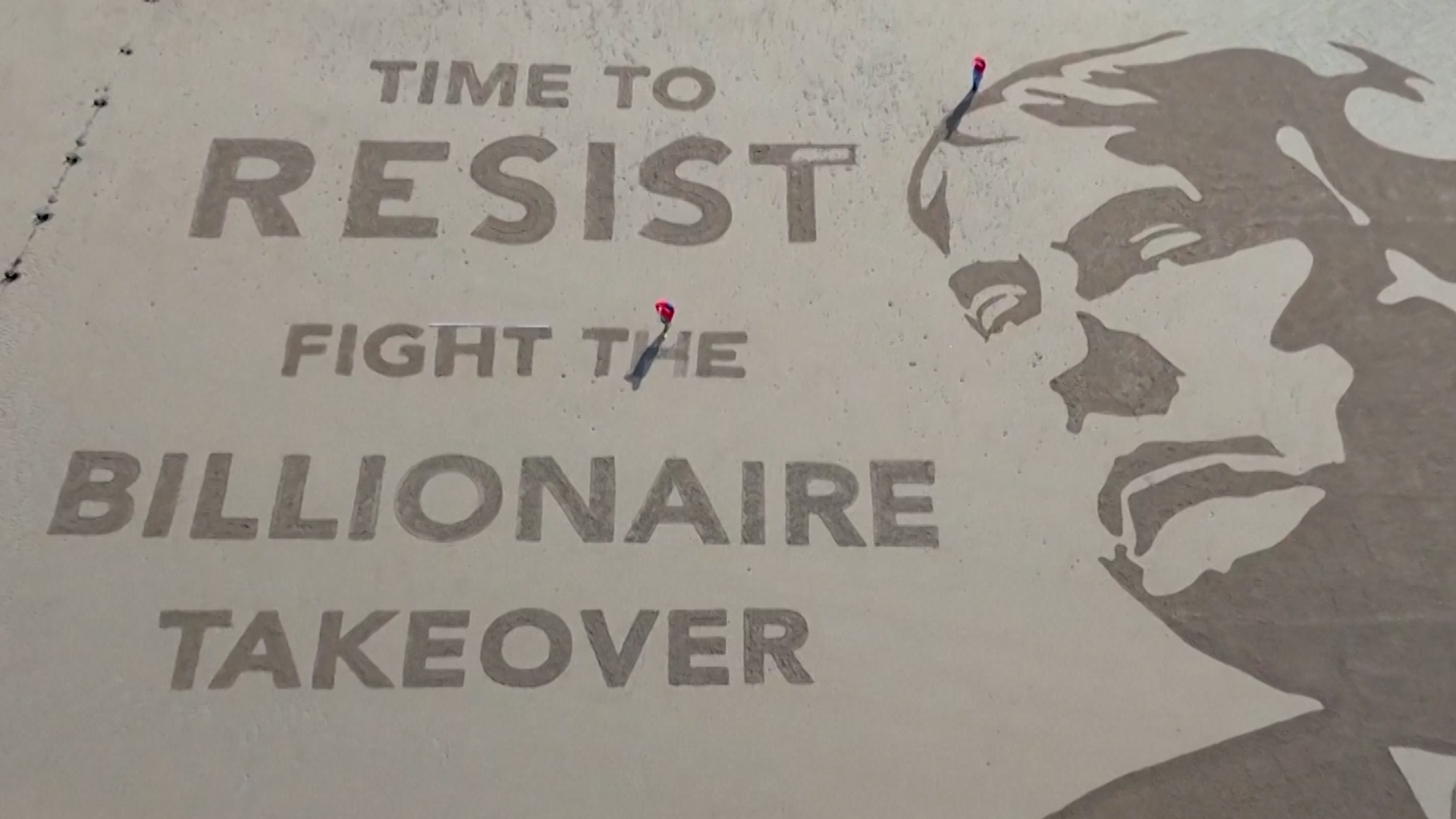 ‘Time to resist’: Protesters etch Trump portrait in sand