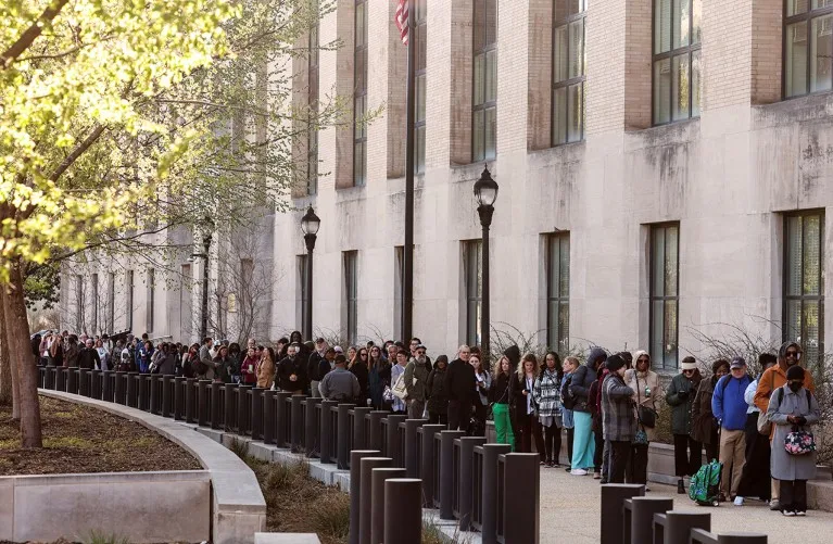 A long queue of employees at the Department of Health and Human Services (HHS) outside their building after the Trump administration fired staff.
