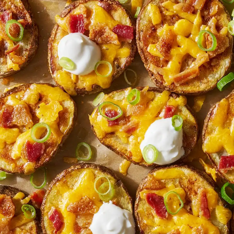 Potato Skin Bites circles of crispy potatoes with melted cheese, bacon and dollops of sour cream
