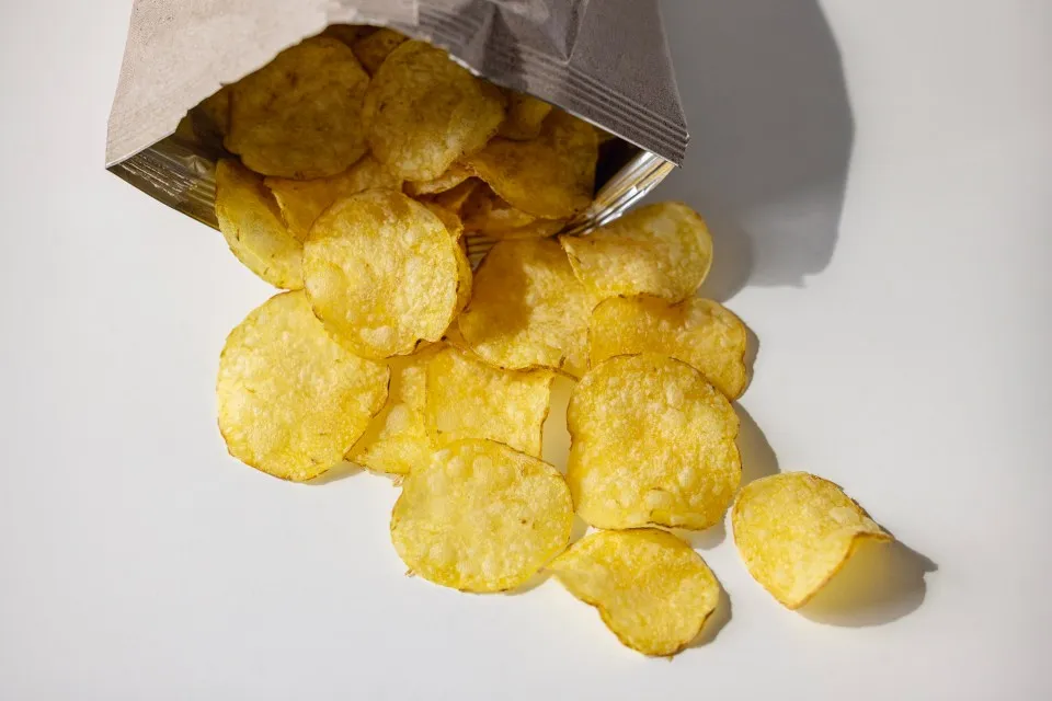 Potato chips spilling from a bag.