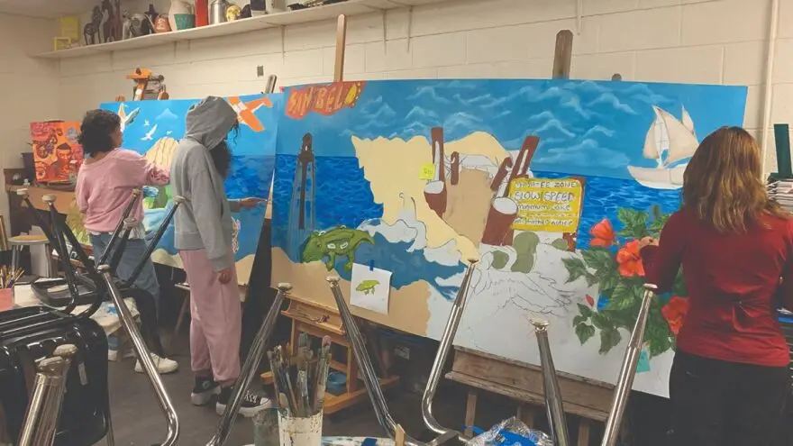 Photo of Cypress Lake High School students working on 'A Shell in Time' mural.