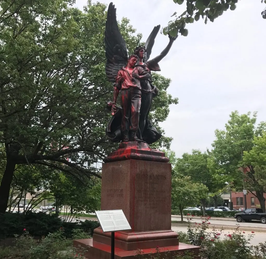 A statue of a female winged figure and a soldier, a Confederate monument, has been splashed with red paint